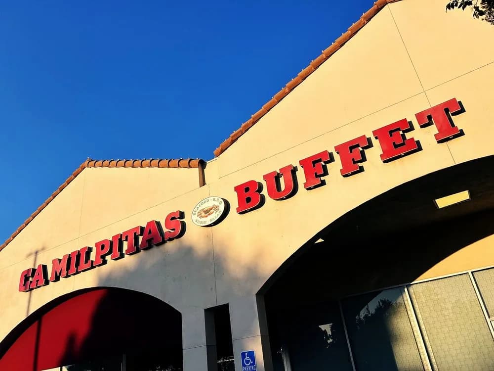 Close view of the CA Milpitas Buffet sign with its seafood, BBQ, sushi and salad emblem