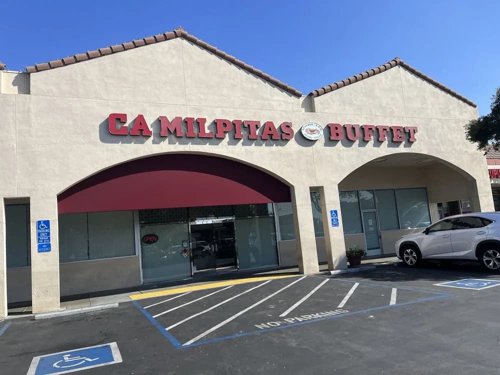 The CA Milpitas Buffet building and parking lot seen from the street